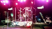 FM drum kit behind perspex screen